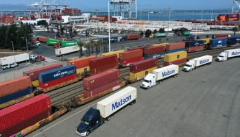 Trucks with shipping containers sit on a dock at the Port of Oakland on September 09, 2021.