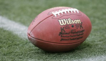 Close-up image of a football on a playing field.