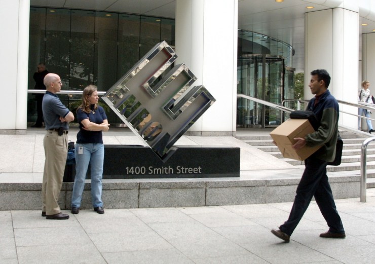 Enron employees leave the company's Houston headquarters after being laid off in 2001.