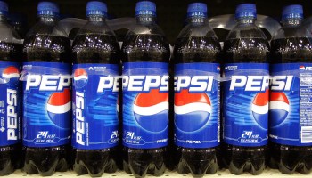 Plastic Pepsi bottles on a store shelf.