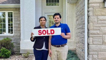 Dr. Zarrish Kahn and her husband in front of their new home in Iowa City, Iowa, in June.
