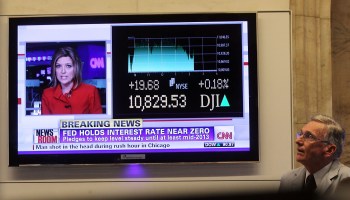 In 2011, a TV news report shows the Federal Reserve decision to keep interest rates near zero until 2013.