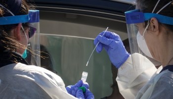 Medical professionals from Children's National Hospital administering a coronavirus test at a drive-thru testing site back in April of 2020.