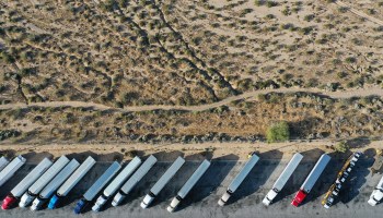 BARSTOW, CALIFORNIA - MAY 23: An aerial view of trucks parked at a truck stop amid the COVID-19 pandemic on May 23 in Barstow, California.