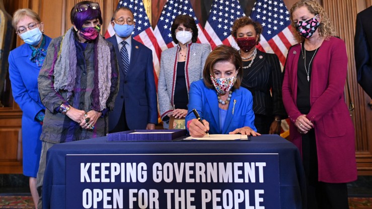 House Speaker Nancy Pelosi signs a bill at the Capitol on Sept. 30 to fund the U.S. government and avoid a federal shutdown.
