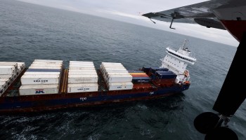 A belgian Coast Guard Sniffer planes flies over a container ship in search of illegal pollution, in Northern sea, on September 30, 2021.