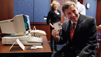 Sen. Mark Kirk poses with a floppy disk and an old computer at a news conference about the 25th anniversary of the Electronic Communications Privacy Act .