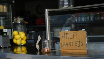 A Help Wanted sign is displayed at a boardwalk restaurant.
