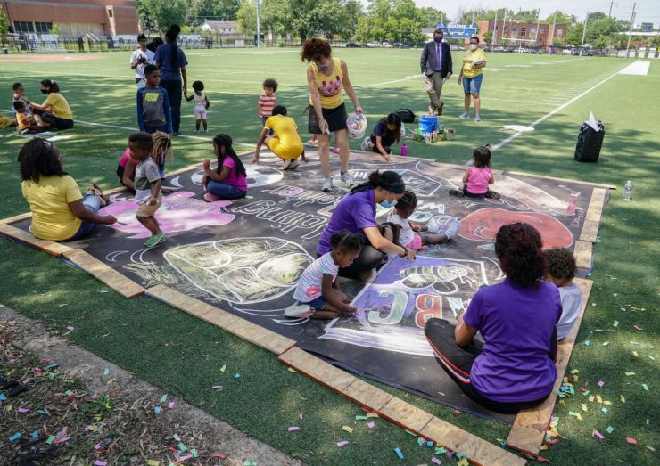 Children and teachers from the KU Kids Deanwood Childcare Center complete a mural in celebration of the launch of the Child Tax Credit on July 14, 2021 at the KU Kids Deanwood Childcare Center in Washington, DC.