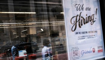 A hiring sign is displayed in a store window in Manhattan on August 19, 2021 in New York City.