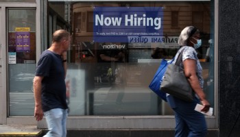 A hiring sign is displayed in a store window in Manhattan on Aug. 19 in New York City.