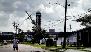 A woman looks over damage to a neighborhood caused by Hurricane Ida on August 30, 2021 in Kenner, Louisiana.