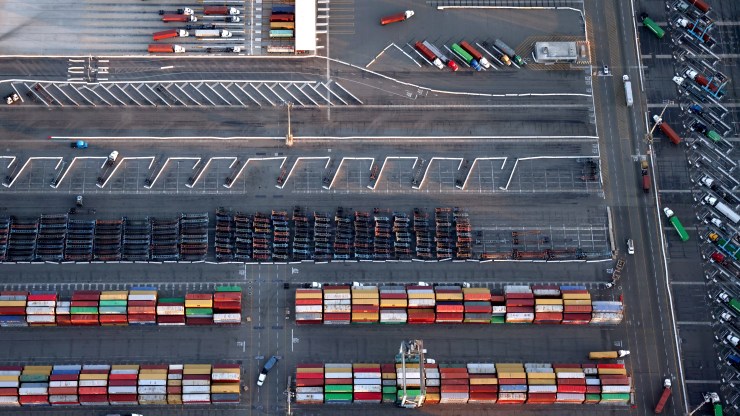 LOS ANGELES, CALIFORNIA - SEPTEMBER 20: In an aerial view, shipping containers and trucks are seen at the Port of Los Angeles on September 20, 2021 near Los Angeles, California. Amid nationwide record-high demand for imported goods and supply chain issues, the twin ports of Los Angeles and Long Beach are currently seeing unprecedented congestion. On September 17, there were a record total of 147 ships, 95 of which were container ships, in the twin ports, which move about 40 percent of all cargo containers entering the U.S. (Photo by Mario Tama/Getty Images)