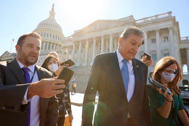 Sen. Joe Manchin reacts to a question about carbon tax as he walks back to his office following votes at the U.S. Capitol on September 29, 2021 in Washington, DC.