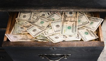 Piles of cash hidden in a drawer.