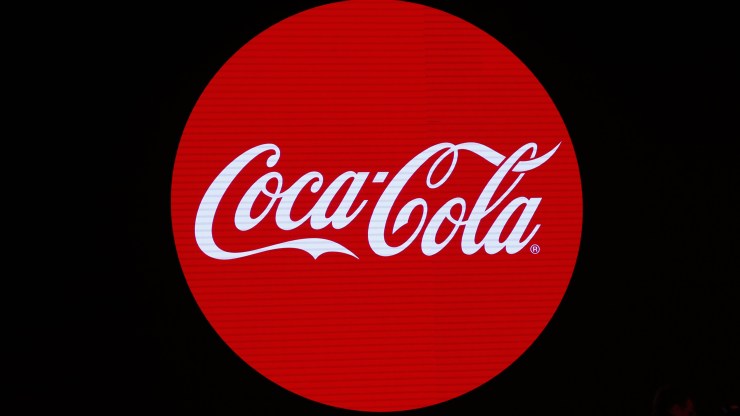The Coca-Cola logo: Coca-Cola is written in white script on a red circle.