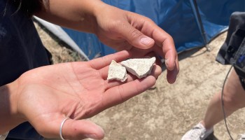 Daranda Hinkey holds some pieces of clay containing lithium, or “white gold,” that could be key to a decarbonized future.