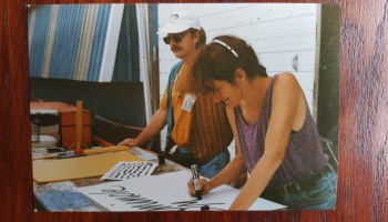 Nan Parati makes a sign at the New Orleans Jazz & Heritage Festival circa 1990.