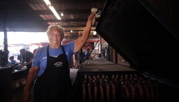 Tootsie Tomanetz, the 86-year-old pitmaster at Snow's BBQ, tends to sausages on a Saturday morning in Lexington, Texas.