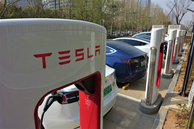 A row of Tesla charging stations in front of one of Luoyang's priciest office blocks. Starting in 2025, China plans to have 20% of new cars sales consist of electric, hybrid or hydrogen fuel cell vehicles. (Charles Zhang/Marketplace)
