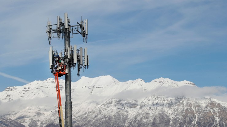 A contract crew for Verizon, works on a cell tower to update it to handle the new 5G network in Orem, Utah on December 10, 2019.