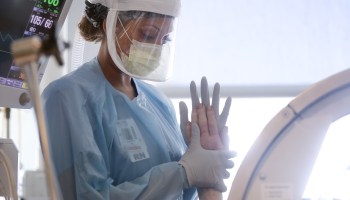 A nurse wears personal protective equipment