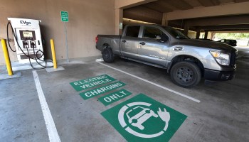 A space remains open for an electric vehicle at an EV charging station. The Biden administration hopes the nation will have half a million of these facilities by 2030.