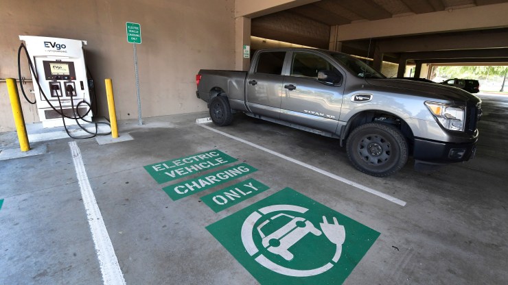 A space remains open for an electric vehicle at an EV charging station. The Biden administration hopes the nation will have half a million of these facilities by 2030.