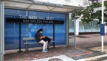 A sign at a Washington, D.C., bus stop showed the amount of the national debt on Oct. 25.