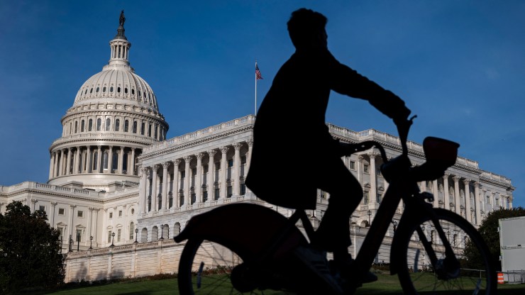 A person rides a bike past Capitol Hill in Washington.