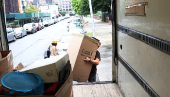 Dusan B., a mover with Rabbit Movers, places the belongings of a customer unto a moving truck on August 13, 2020 in New York City.
