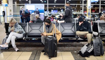 Passengers wait to board an American Airlines flight to Dallas at the Ronald Reagan Washington National Airport on November 24, 2021 in Arlington, Virginia.