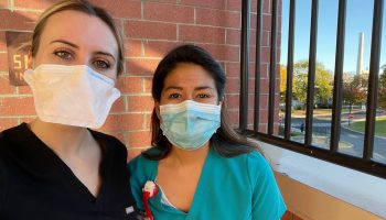 Nurses Klivia Brahja and Kelley Cabrera, with face masks on.
