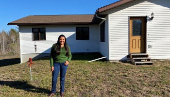 Sarah Sanchez poses for a photo in front of her Bemidji home.