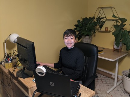 Biota Macdonald sits and smiles for a photo in her home office.
