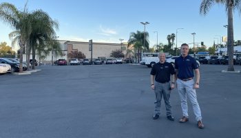 Theo Ebert, right, and Lee Dibble stand on the empty new car lot at Vista Ford Lincoln in Woodland Hills.