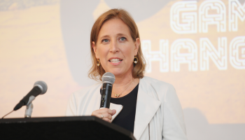 Susan Wojcicki speaks into a microphone at a podium.