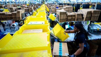 A woman works at a packing station at the 855,000-square-foot Amazon fulfillment center in Staten Island in February 2019.