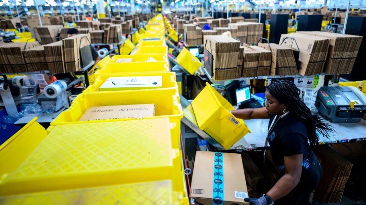 A woman works at a packing station at the 855,000-square-foot Amazon fulfillment center in Staten Island in February 2019.