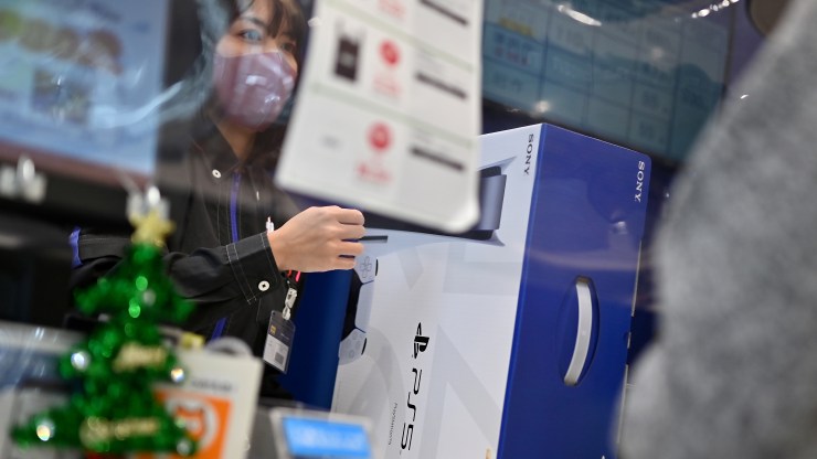 A customer buys the new Sony PlayStation 5 gaming console on the first day of its launch, at an electronics shop in Kawasaki, Kanagawa prefecture on November 12, 2020.