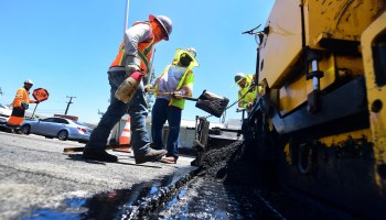 A crew work on road resurfacing on June 24, 2021, in Alhambra, California.