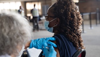 A woman receives a booster dose of the Pfizer-BioNTech coronavirus vaccine during in Michigan.