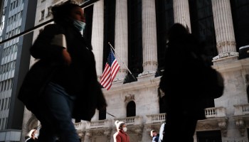 People walk past the New York Stock Exchange in 2020 in New York City.