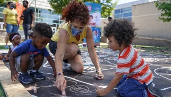 WASHINGTON, DC - JULY 14: Children from the KU Kids Deanwood Childcare Center complete a mural celebrating the launch of the Child Tax Credit on July 14, 2021 at the KU Kids Deanwood Childcare Center in Washington, DC.