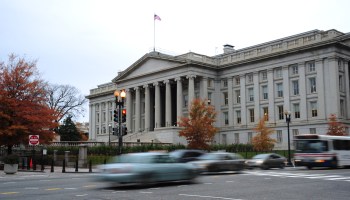 This November 15, 2011 photo shows vehicles as they drive by the US Treasury Building in Washington, DC.