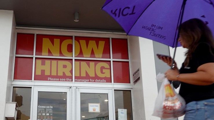 ''Now Hiring" sign hangs above the entrance to a McDonald's restaurant on November 05, 2021 in Miami Beach, Florida.