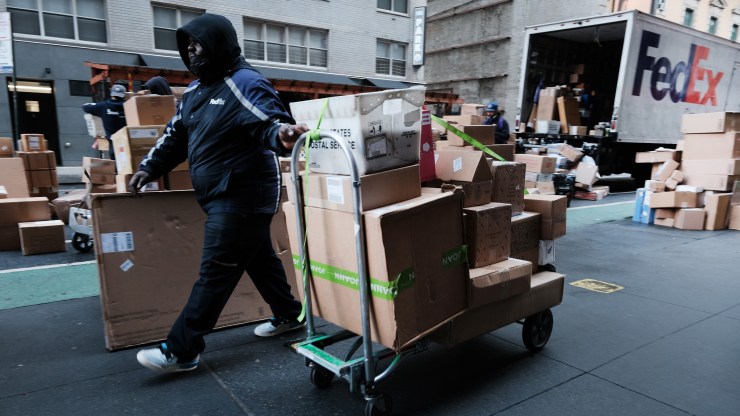 A FedEx worker makes deliveries on December 06, 2021 in New York City.