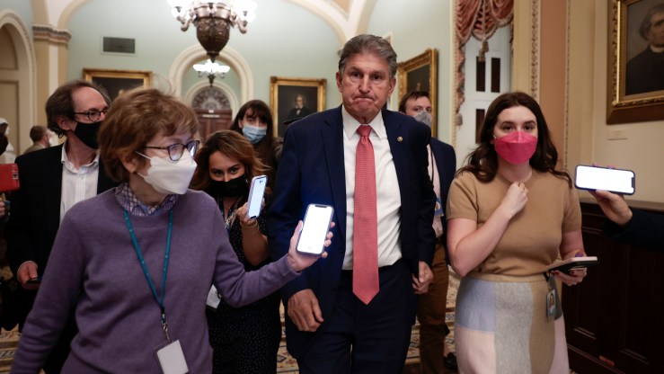 WASHINGTON, DC - DECEMBER 17: Sen. Joe Manchin (D-WV) is followed by reporters as he leaves a caucus meeting with Senate Democrats at the U.S. Capitol Building on December 17, 2021 in Washington, DC. Democrats continue to work on a path forward in regards to the Build Back Better and election reform legislation ahead of the Holiday recess. (Photo by Anna Moneymaker/Getty Images)