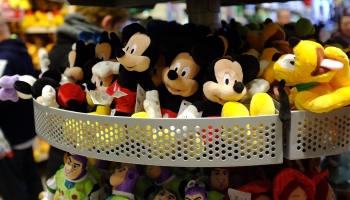 Mickey Mouse, Buzz Lightyear and Pluto plush toys are displayed on a rack at a Disney store in 2012.