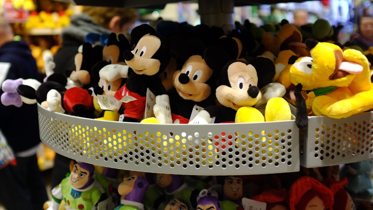 Mickey Mouse, Buzz Lightyear and Pluto plush toys are displayed on a rack at a Disney store in 2012.